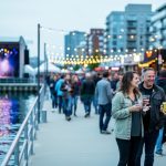 Crowds gather near an outdoor stage and harborfront lights during a multi-genre music festival in Canada’s east, highlighting the city-integrated festival atmosphere.